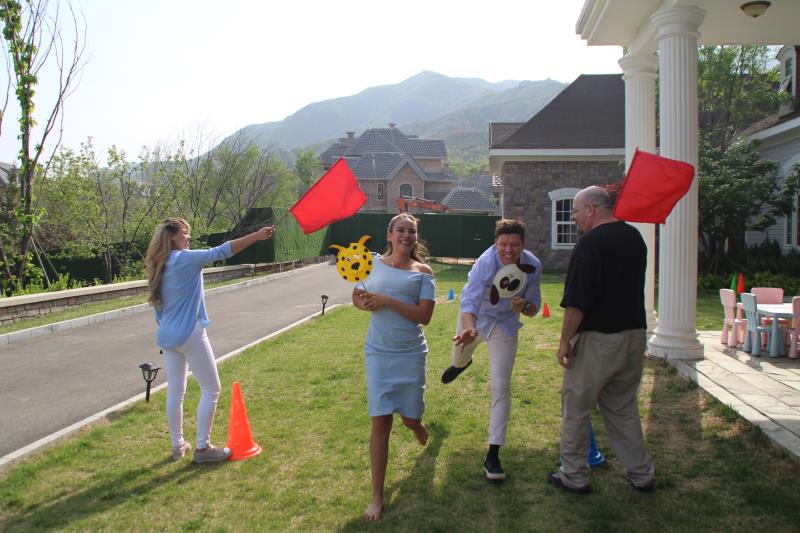 A diverse group of people engaging in a fun and educational group activity during a Family Friends event. The activity fosters connection, teamwork, and learning among participants, creating lasting memories