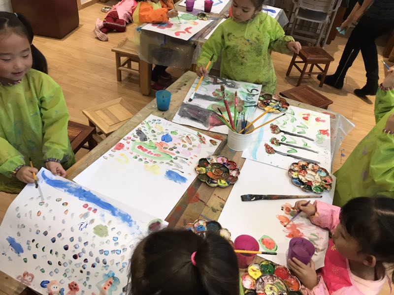 Children playing with crafts at a table, encouraging creativity at Family Friends