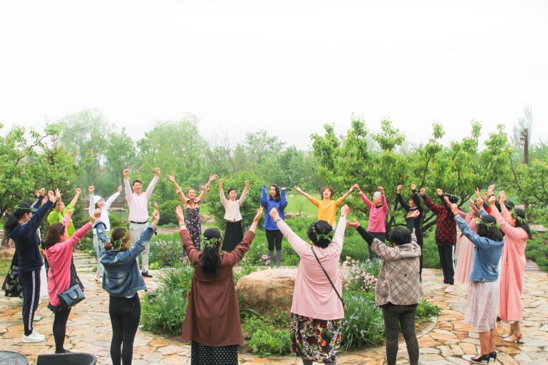 Group of parents gathered in a circle, participating in a Family Friends community event focused on connection and support