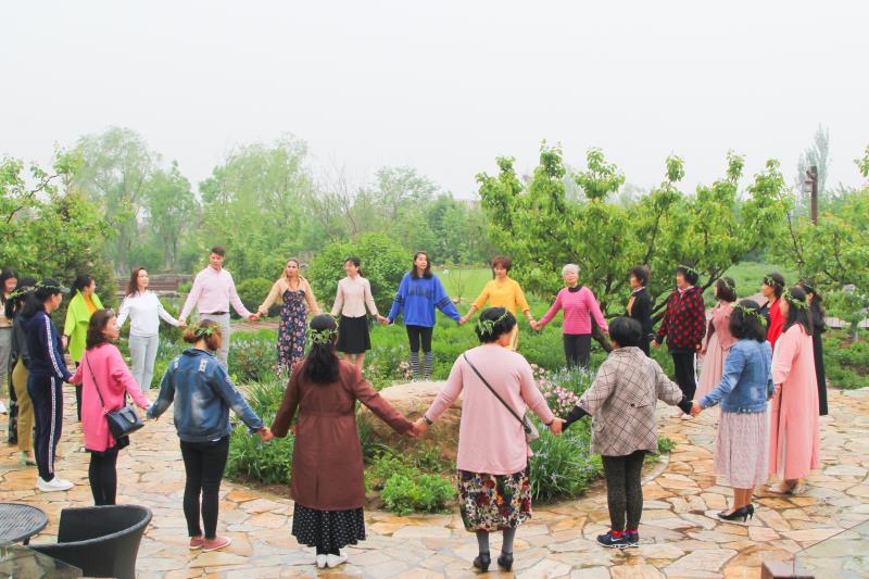 Group of parents gathered in a circle, participating in a Family Friends community event focused on connection and support